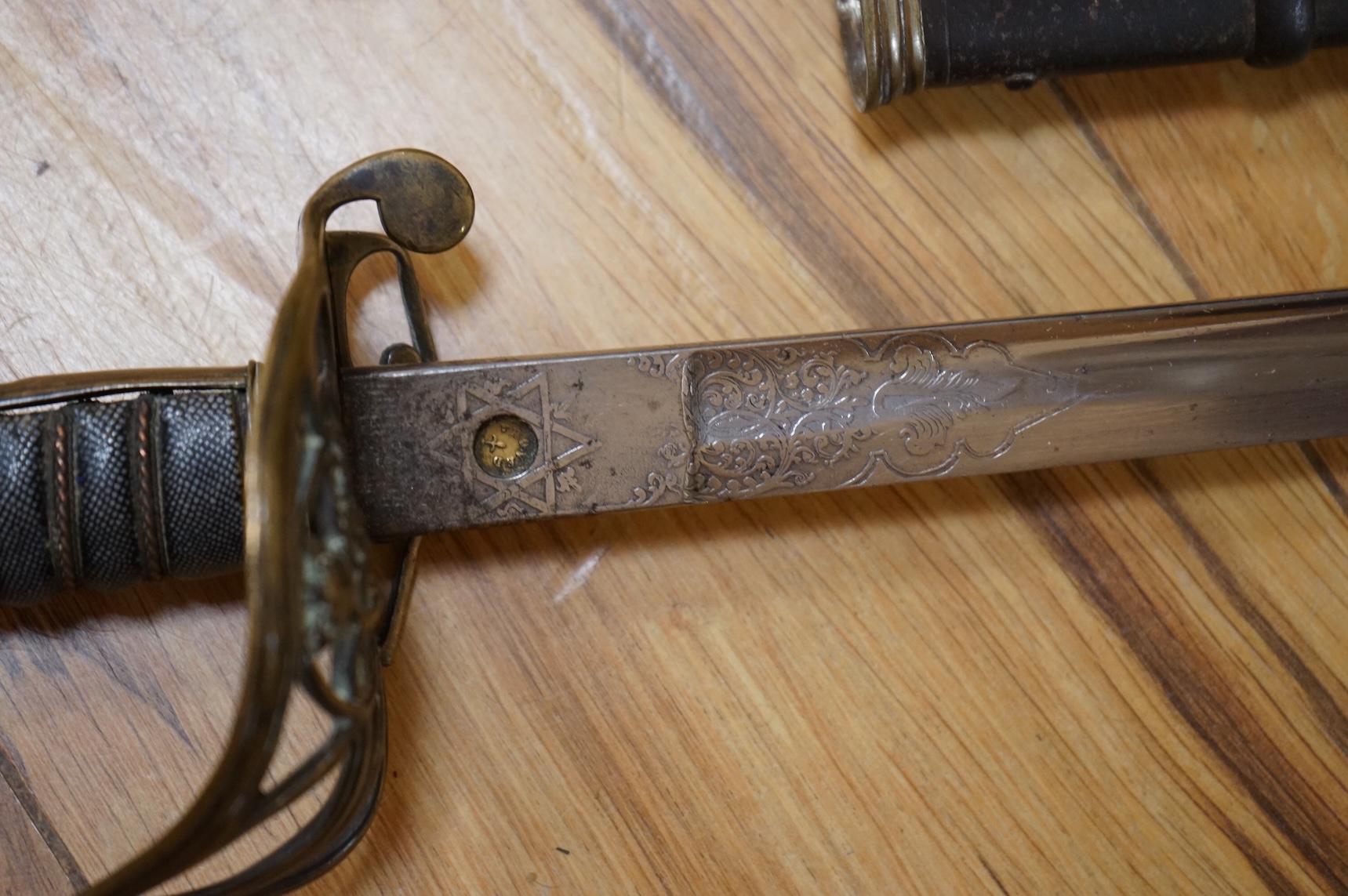 A Victorian 1845 pattern infantry officer’s levee sword, with slender blade etched; Hamburger Rogers & Co., and crowned VR and foliage, regulation pierced brass guard with folding side guard, wire bound fish skin covered